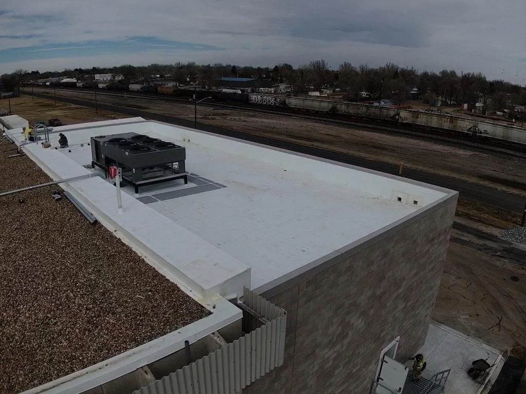 Finished white commercial TPO roof around rooftop HVAC equipment in Colorado