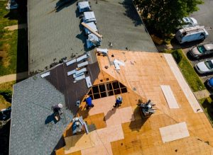 Aerial view of a roof replacement in progress with old shingles removed