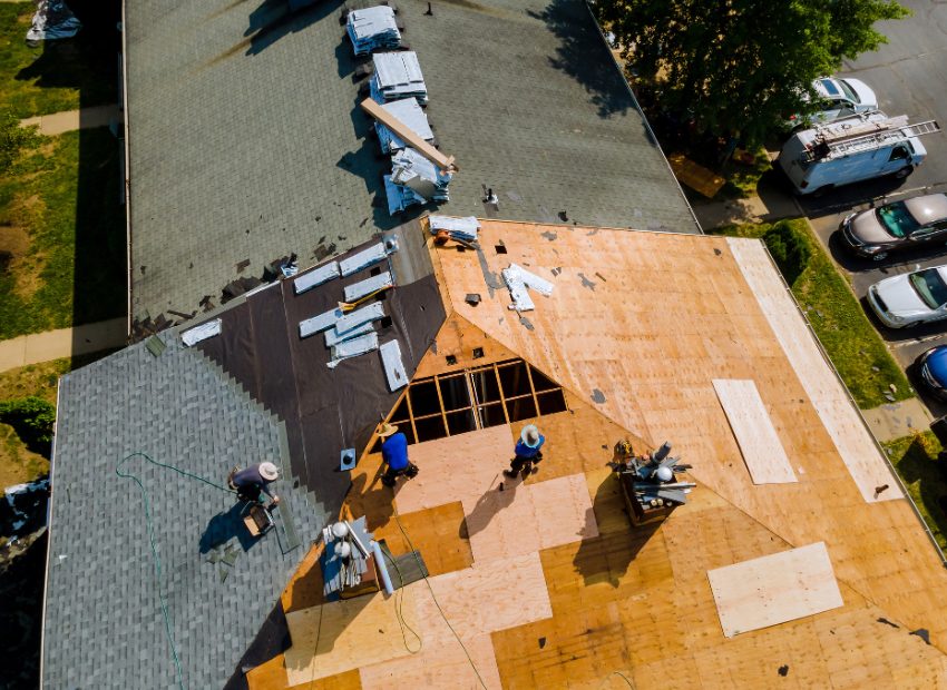 Aerial view of a roof replacement in progress with old shingles removed