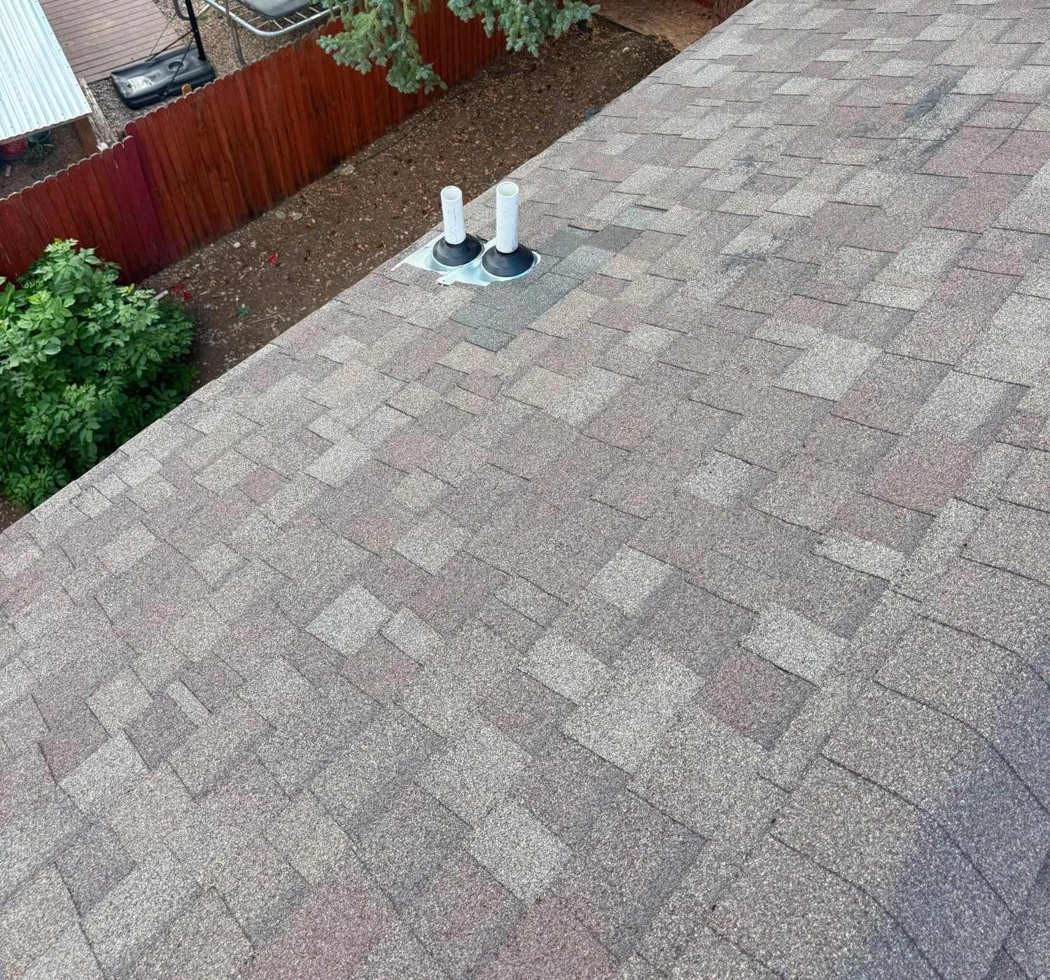 Finished asphalt shingle roof with a vent stack in Arvada, CO