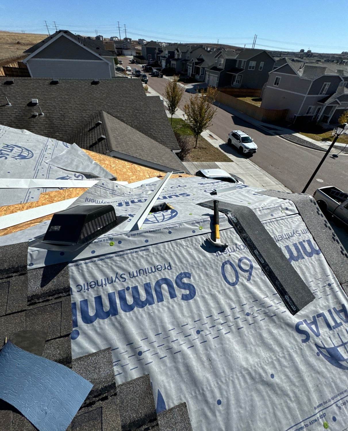 Synthetic underlayment going down before Atlas Pinnacle Impact shingles in Colorado Springs, CO