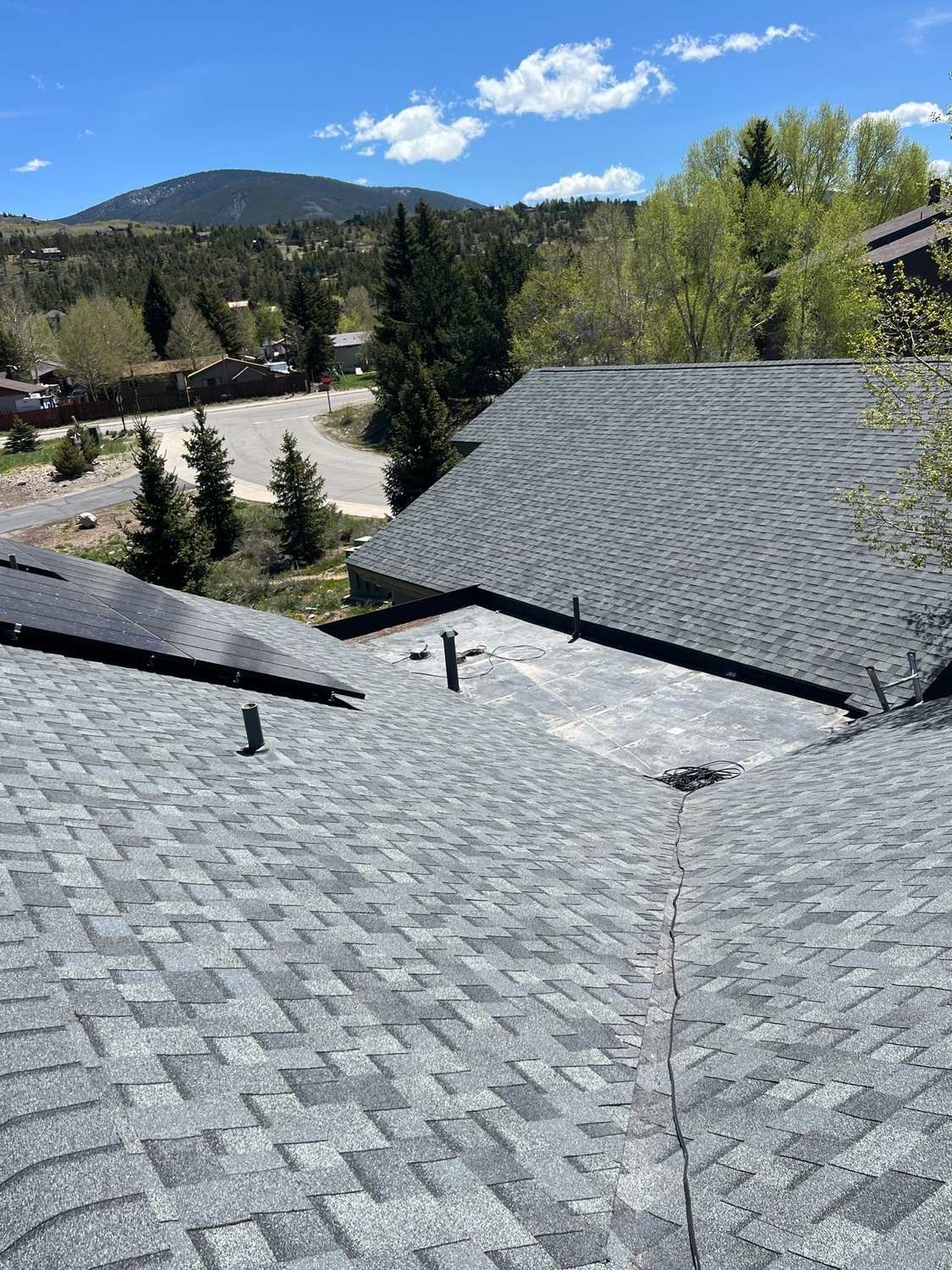 Commercial asphalt shingle roof with mountains in the background in Silverthorne, CO