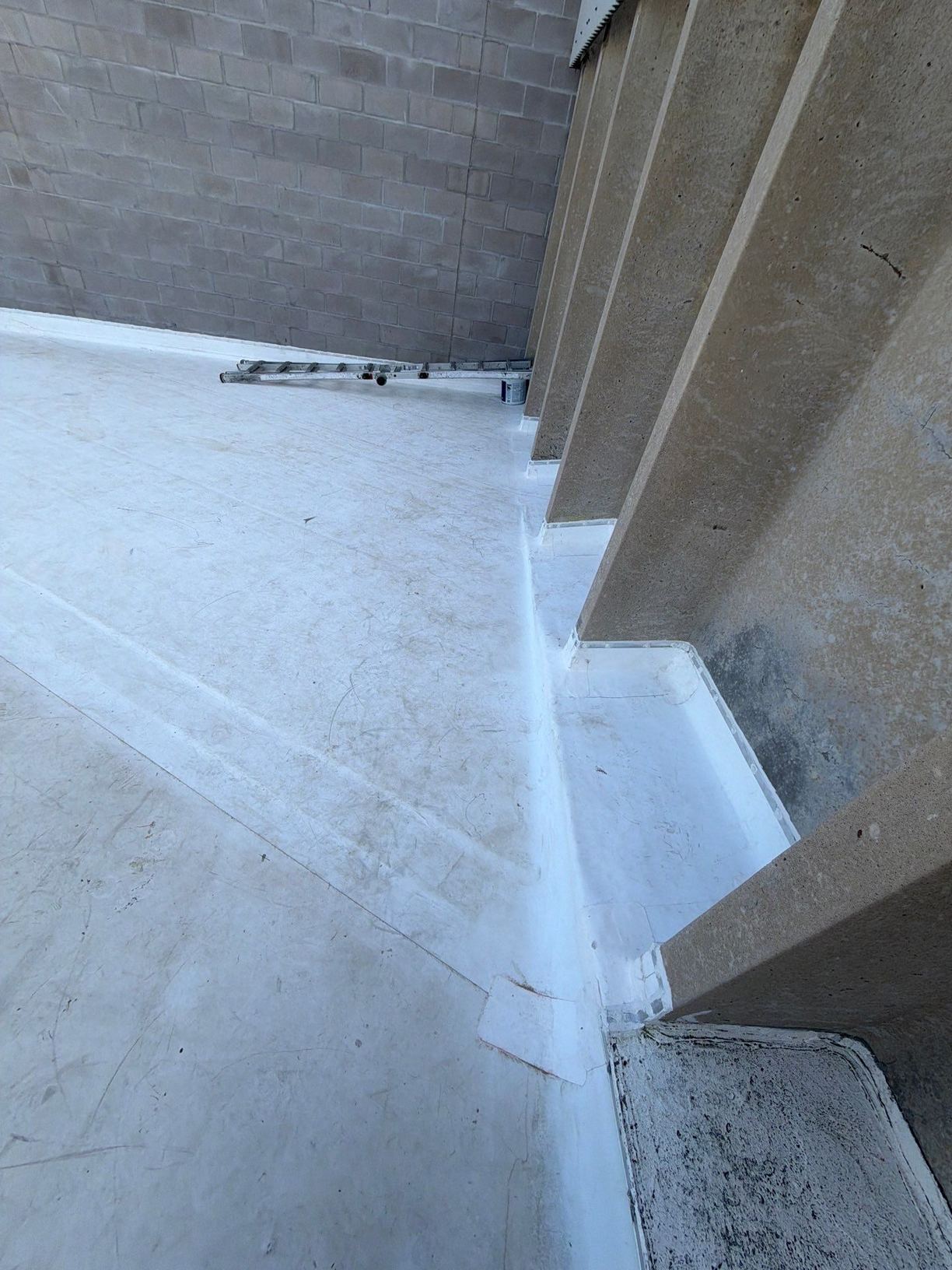 White TPO membrane flashed up a tall block wall with welded inside corners