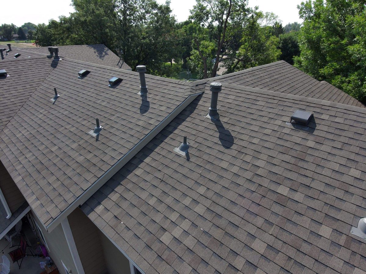 Aerial view of a finished shingle roof on a multifamily townhome building in Fort Collins, Colorado.