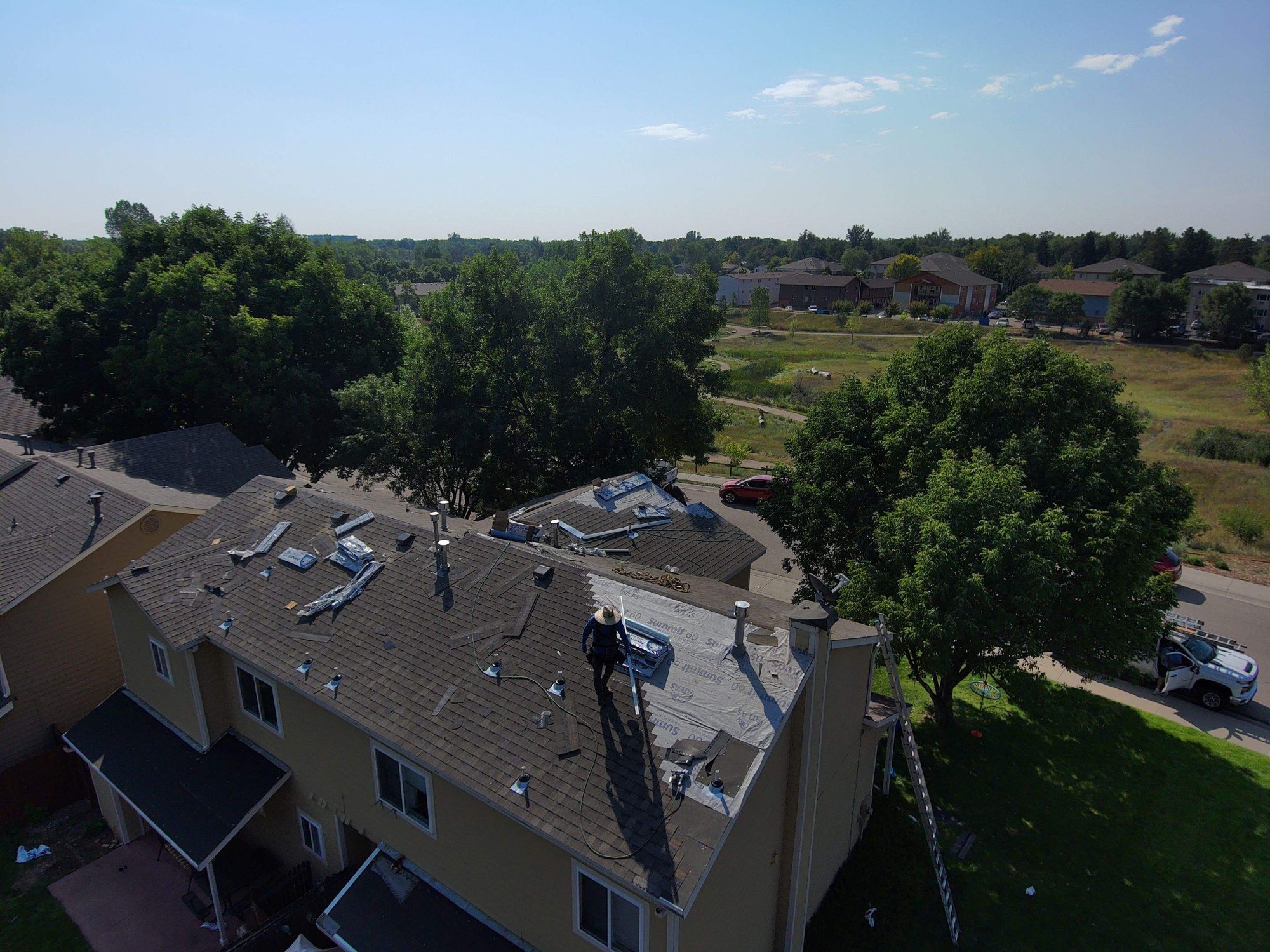 Drone view across finished roofs on a townhome complex in Fort Collins, Colorado.