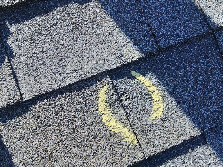 Chalk-circled hail hit on a gray asphalt shingle in Arvada, CO