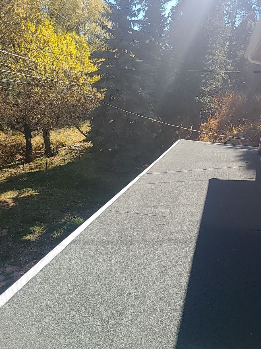 Modified bitumen roof edge finished with white gravel-stop metal