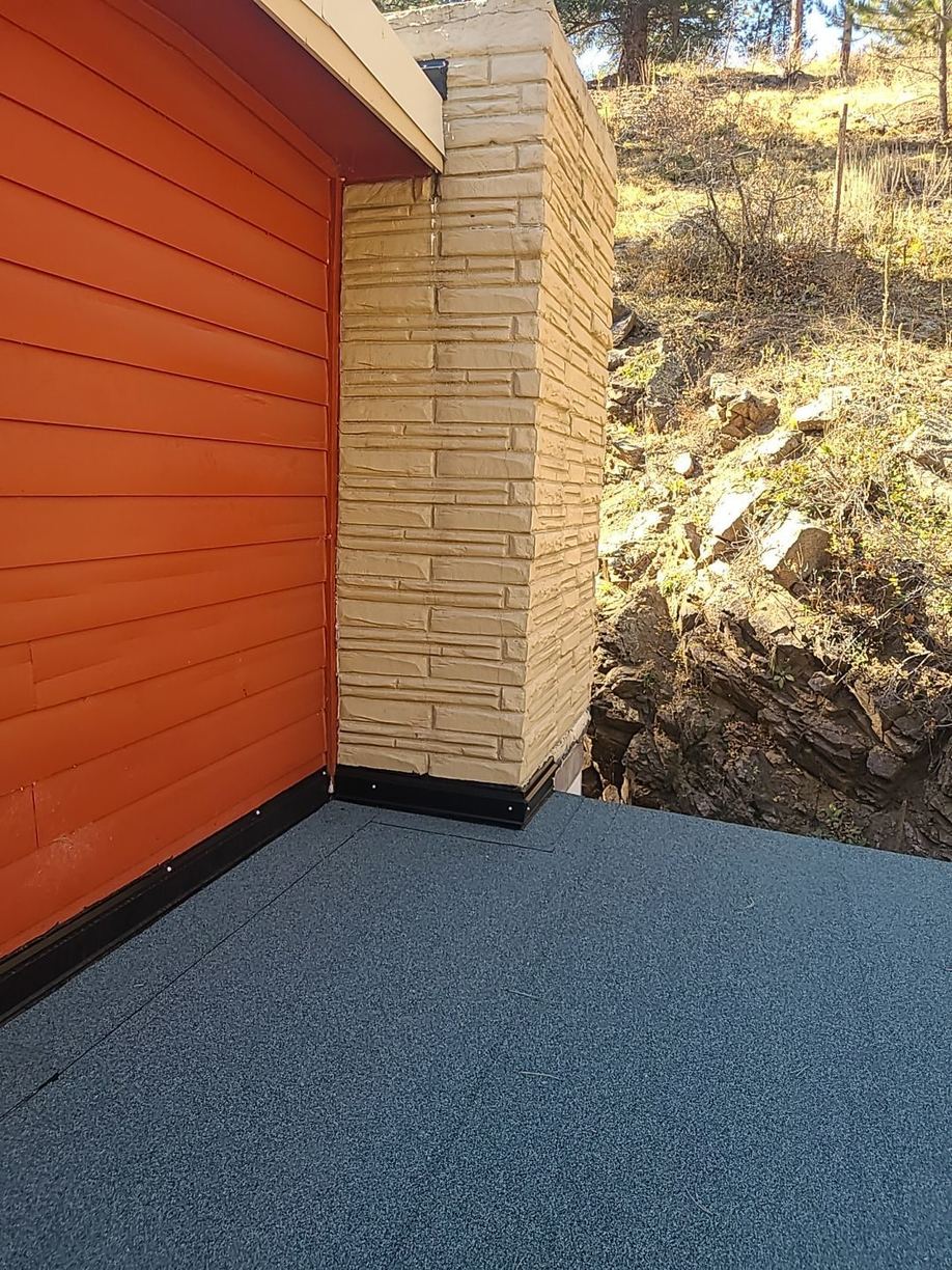 Modified bitumen cap sheet terminated at a siding wall with metal flashing