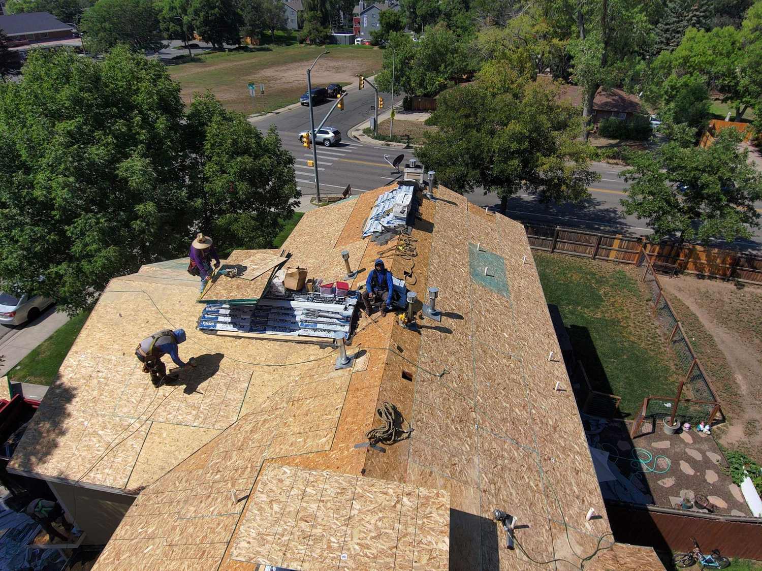 New roof decking going down on a multifamily townhome roof before Atlas Pinnacle Impact shingles in Fort Collins, CO