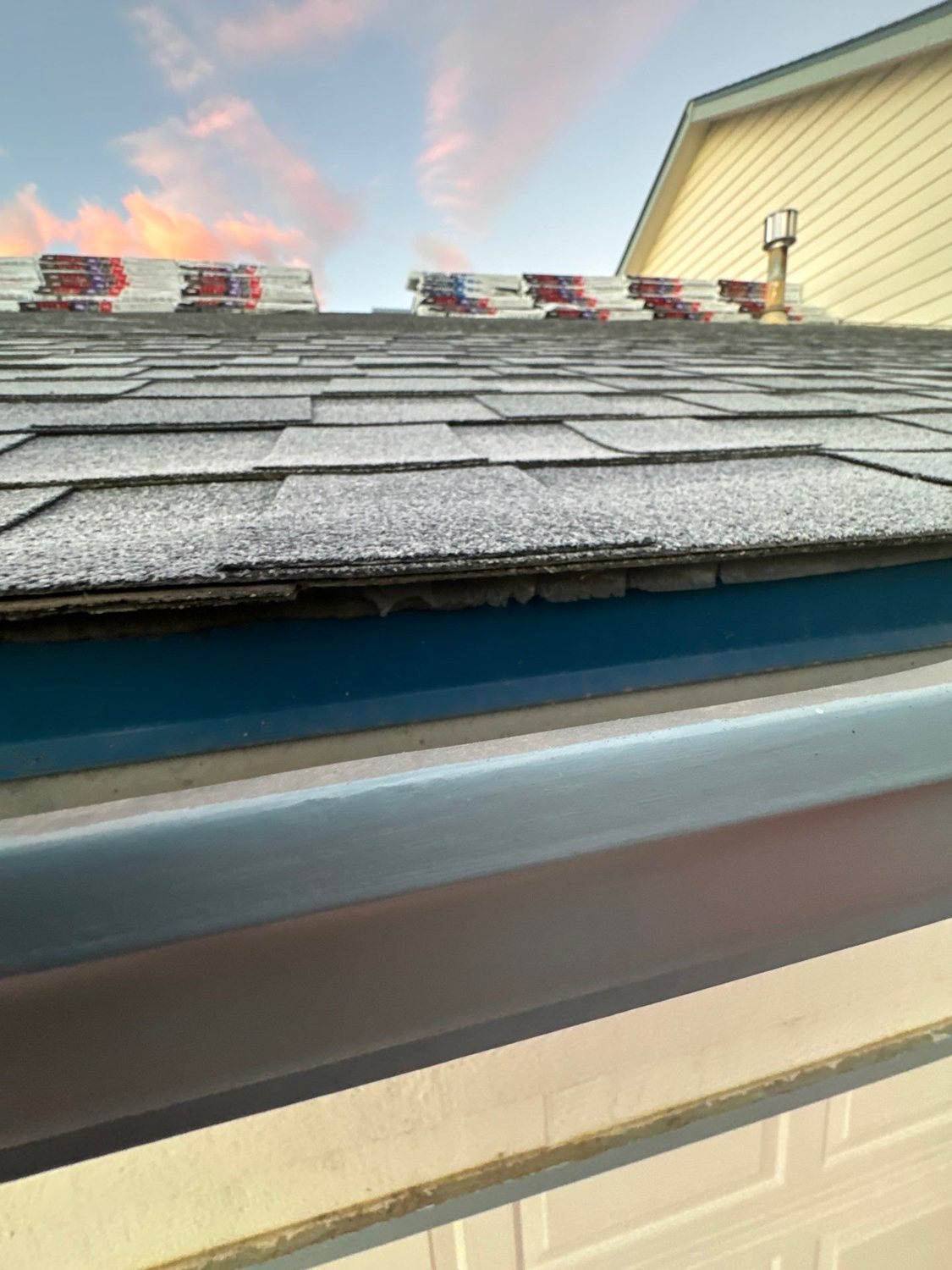 New seamless gutter along the eave under a new shingle roof in Johnstown, CO