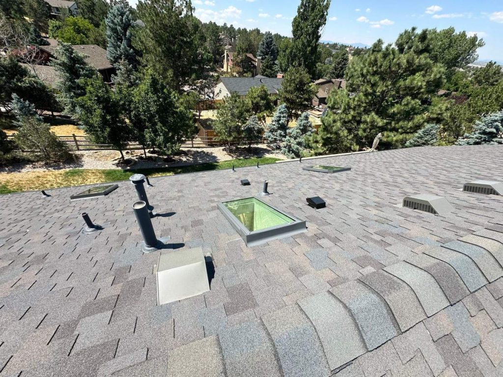 Skylights flashed into a new shingle roof on a reroof in Parker, CO