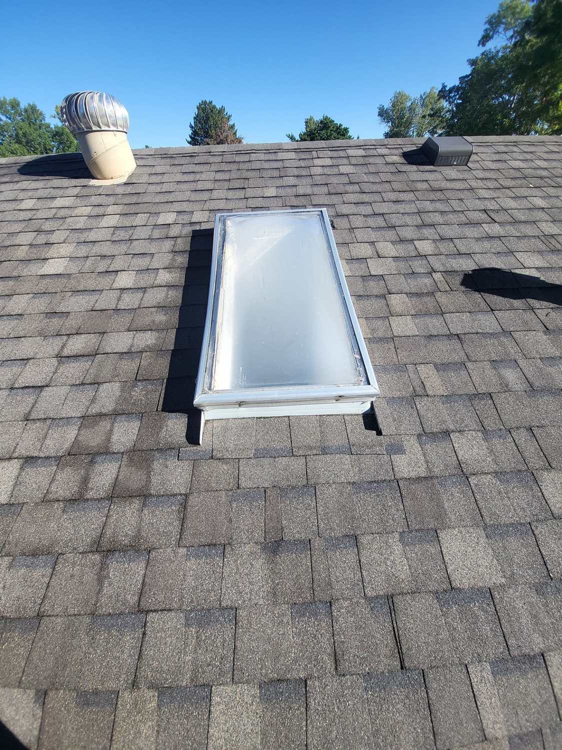 Finished skylight flashed into a new asphalt shingle roof in Littleton, CO