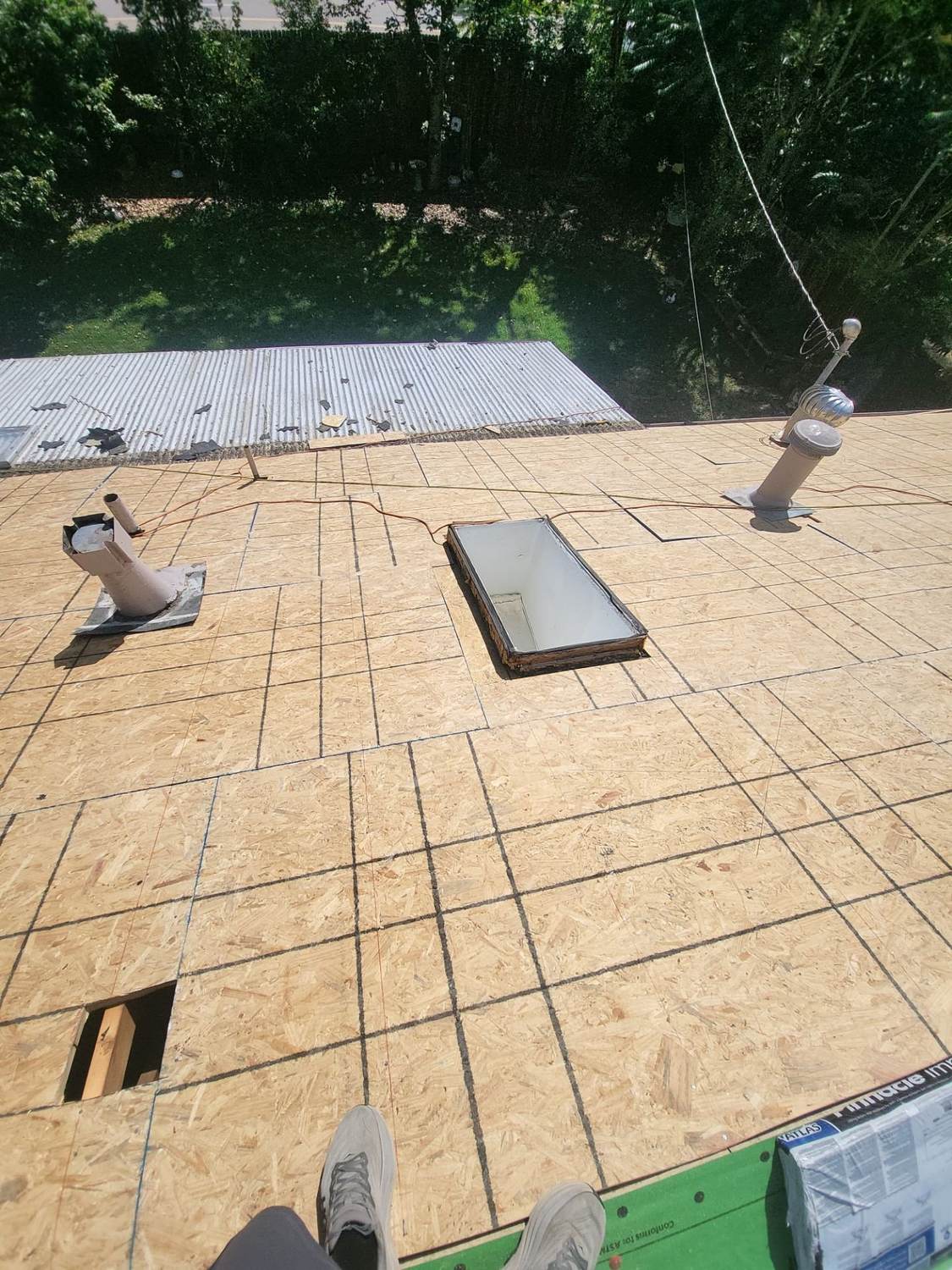 Skylight set on bare roof decking during a reroof in Littleton, CO