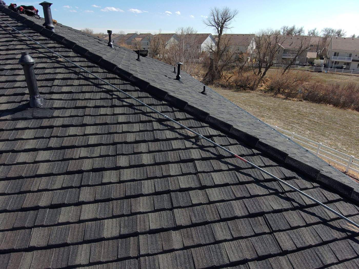 Stone-coated steel roof with Cap Shake hip trim and roof vents, Westlake Royal Cottage Shingle in Charcoal