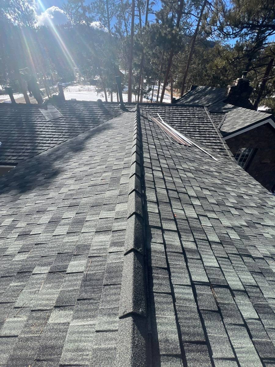 Ridge cap line across an Iron Wood stone-coated steel Cottage Shingle roof