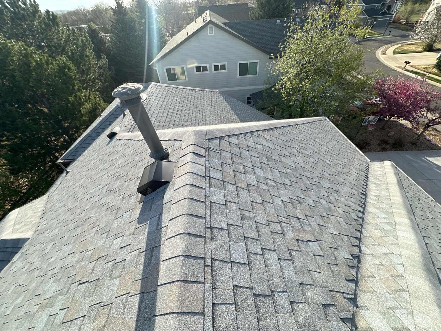TAMKO StormFighter Flex shingle roof with ridge vents and a vent stack in Arvada, CO