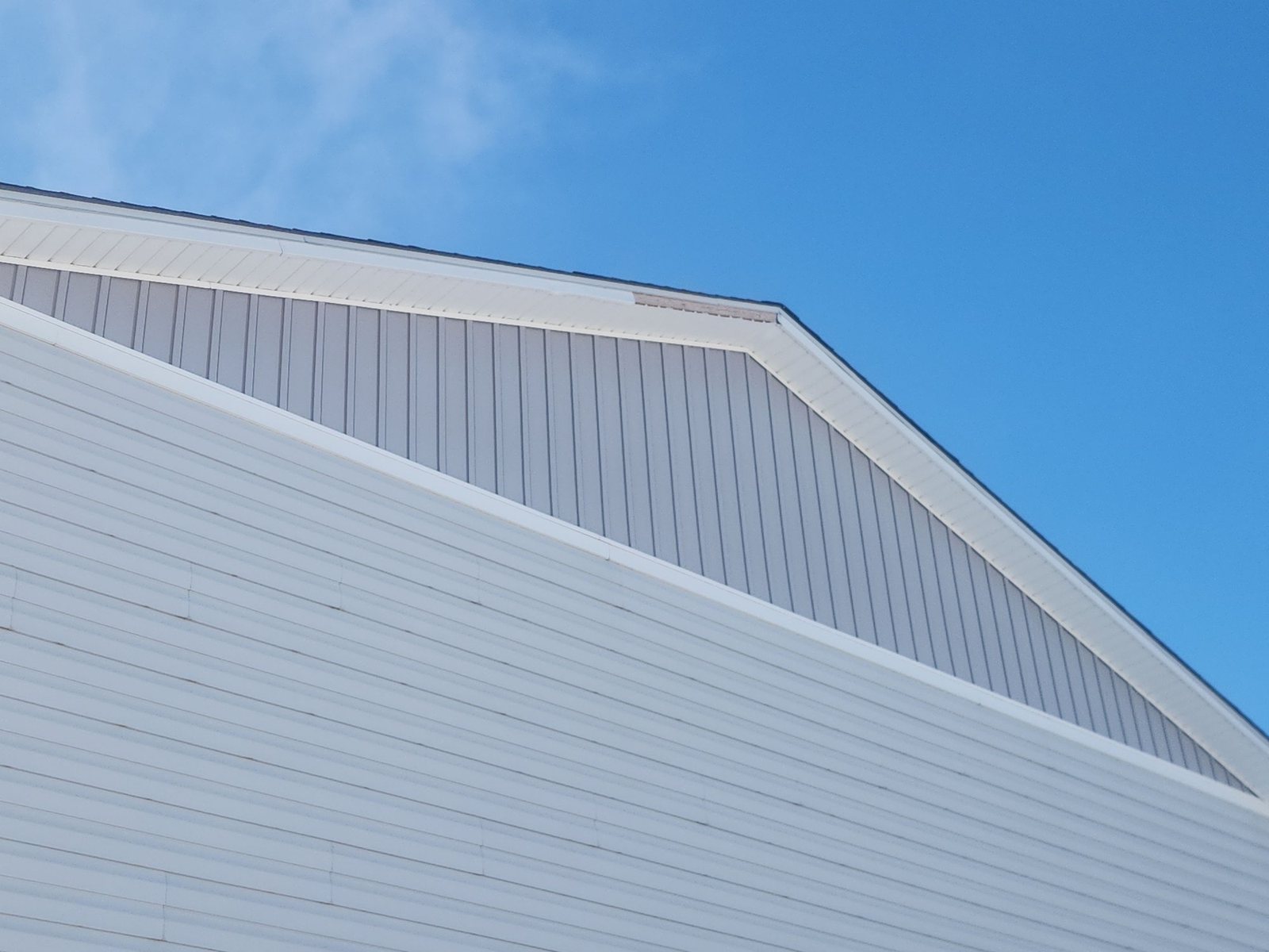 Vinyl siding with board-and-batten gable in Wiggins, CO