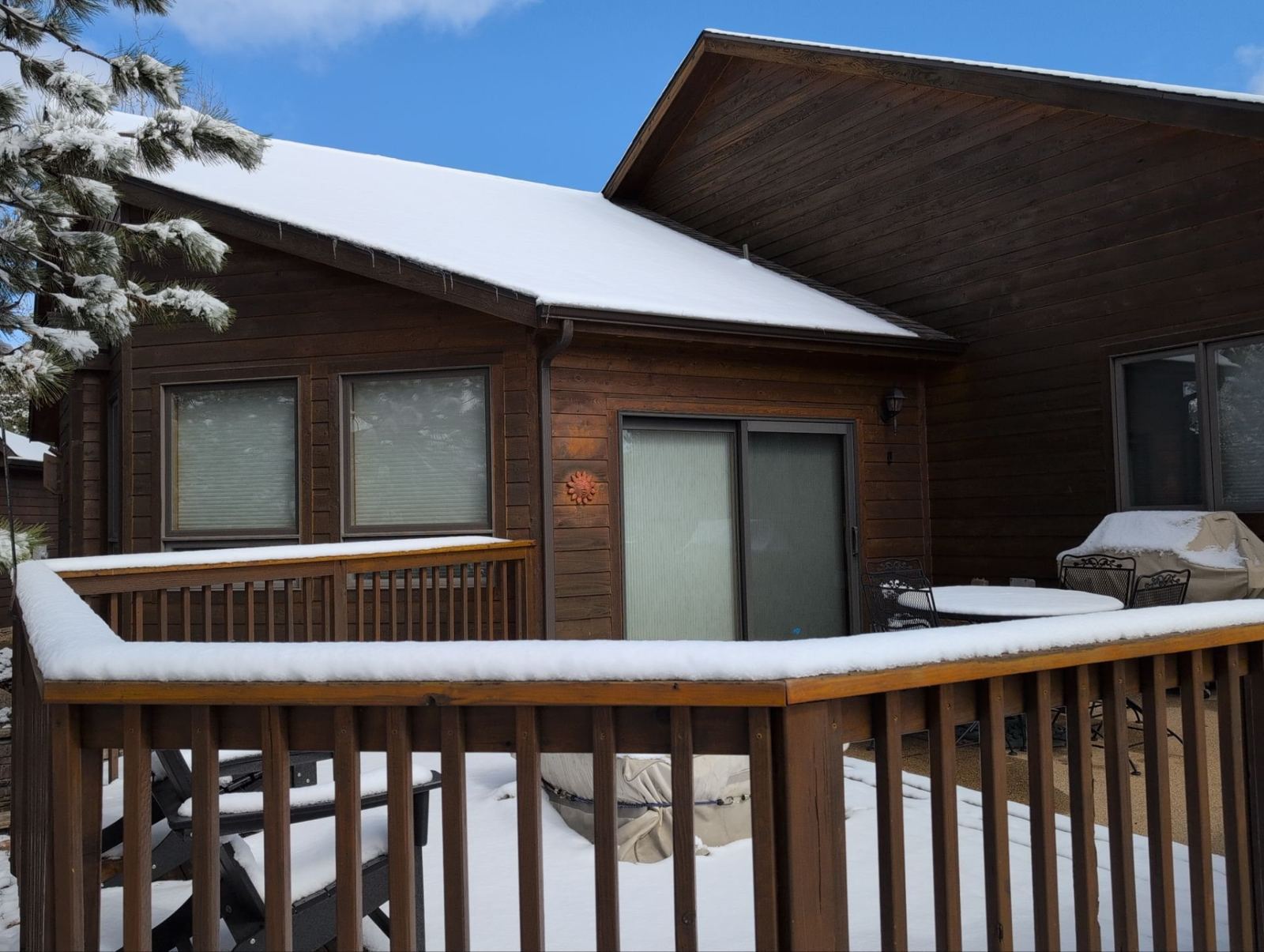 Before window replacement: original dark-framed windows and patio slider